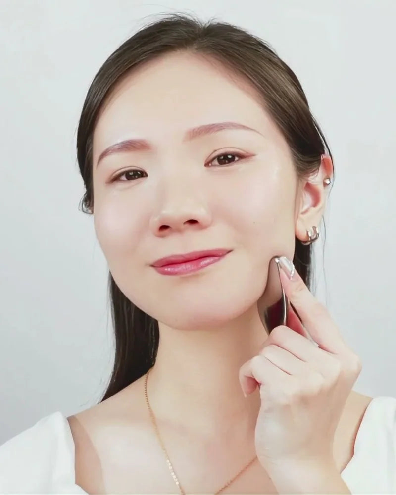 A model smoothing the oil into her cheek
